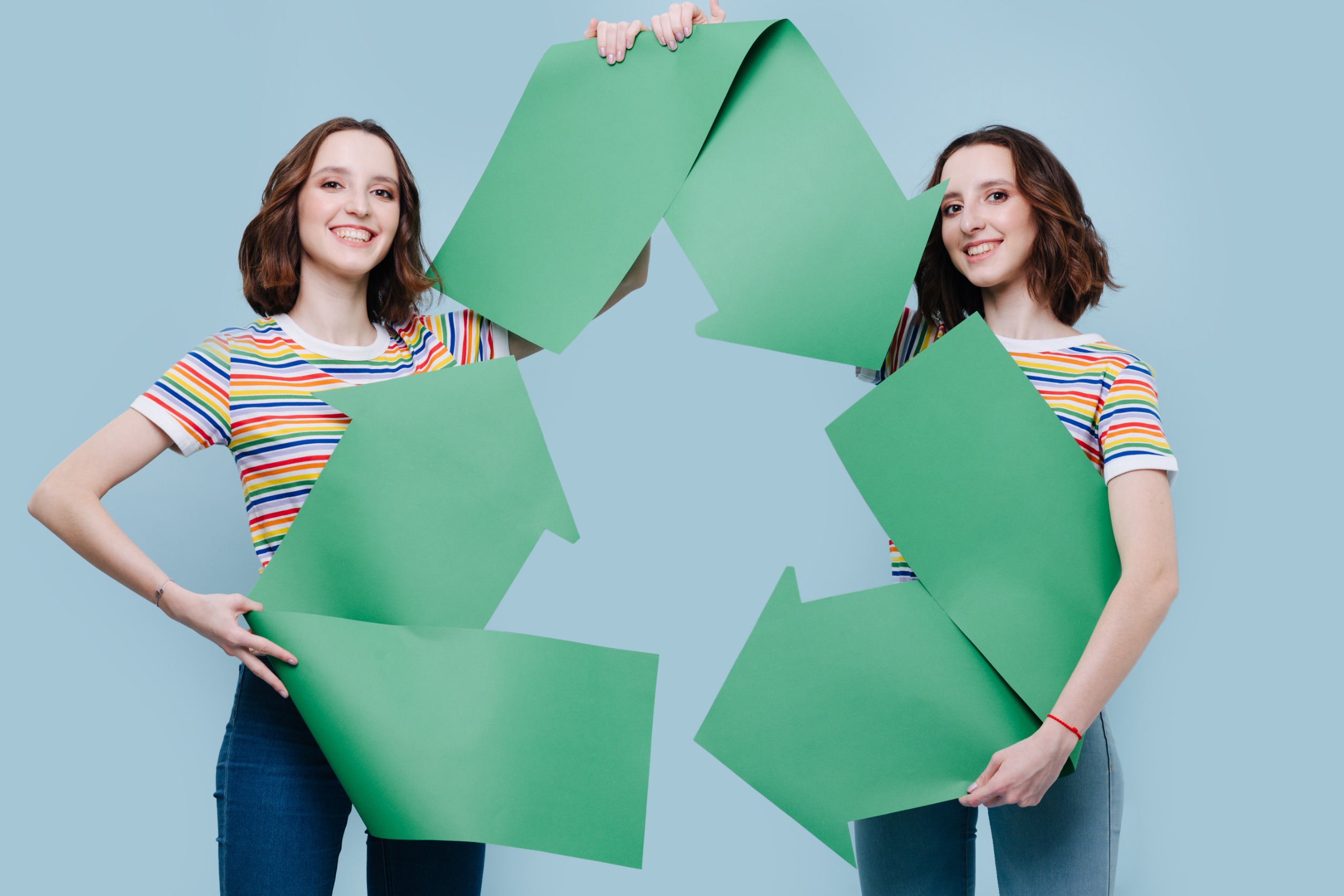girls holding a recycle sign
