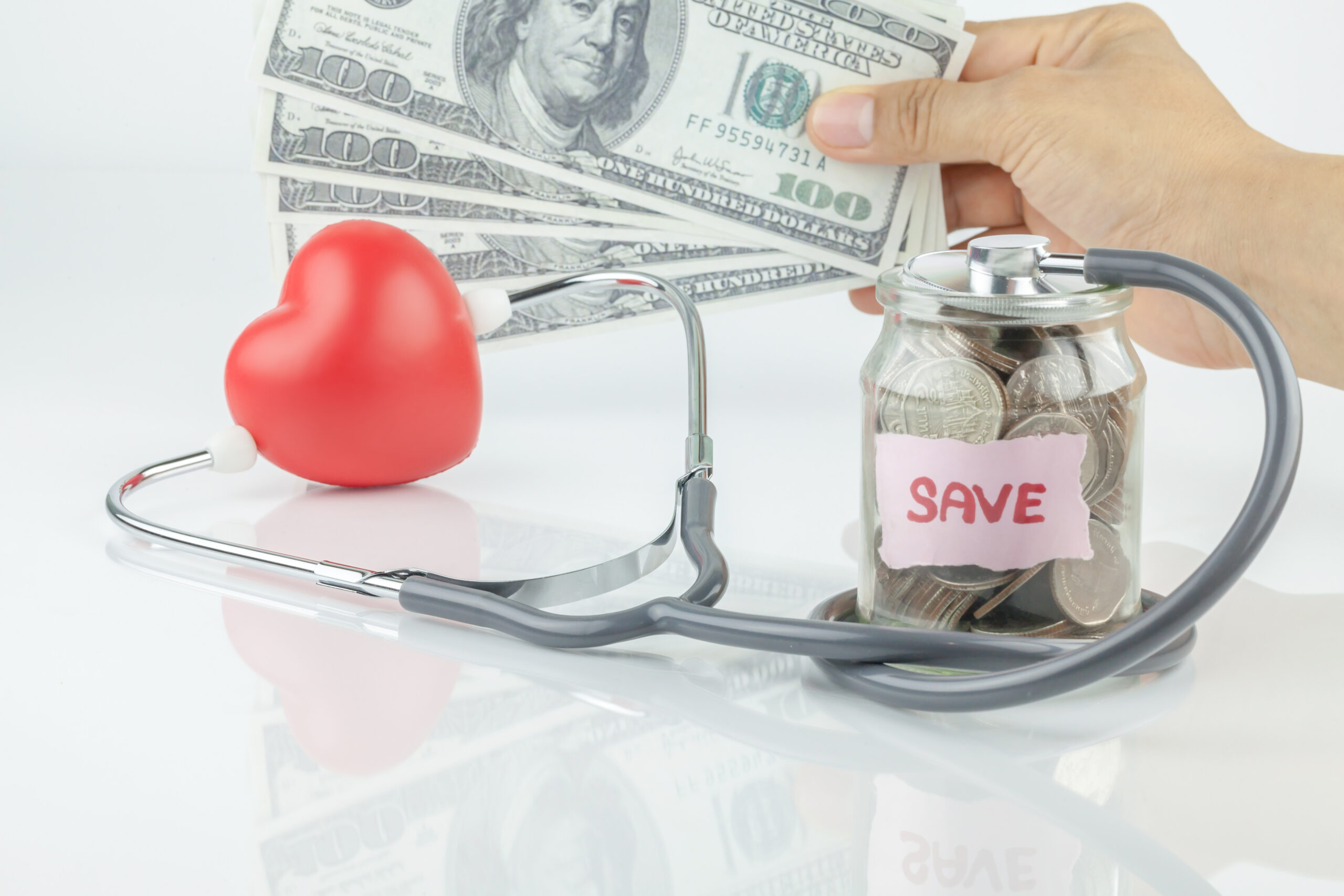 Jar of saving coin and stethoscope