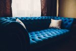 Pretty simple decor of living room with blue sofa and light