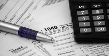 US tax form 1040 with pen and calculator