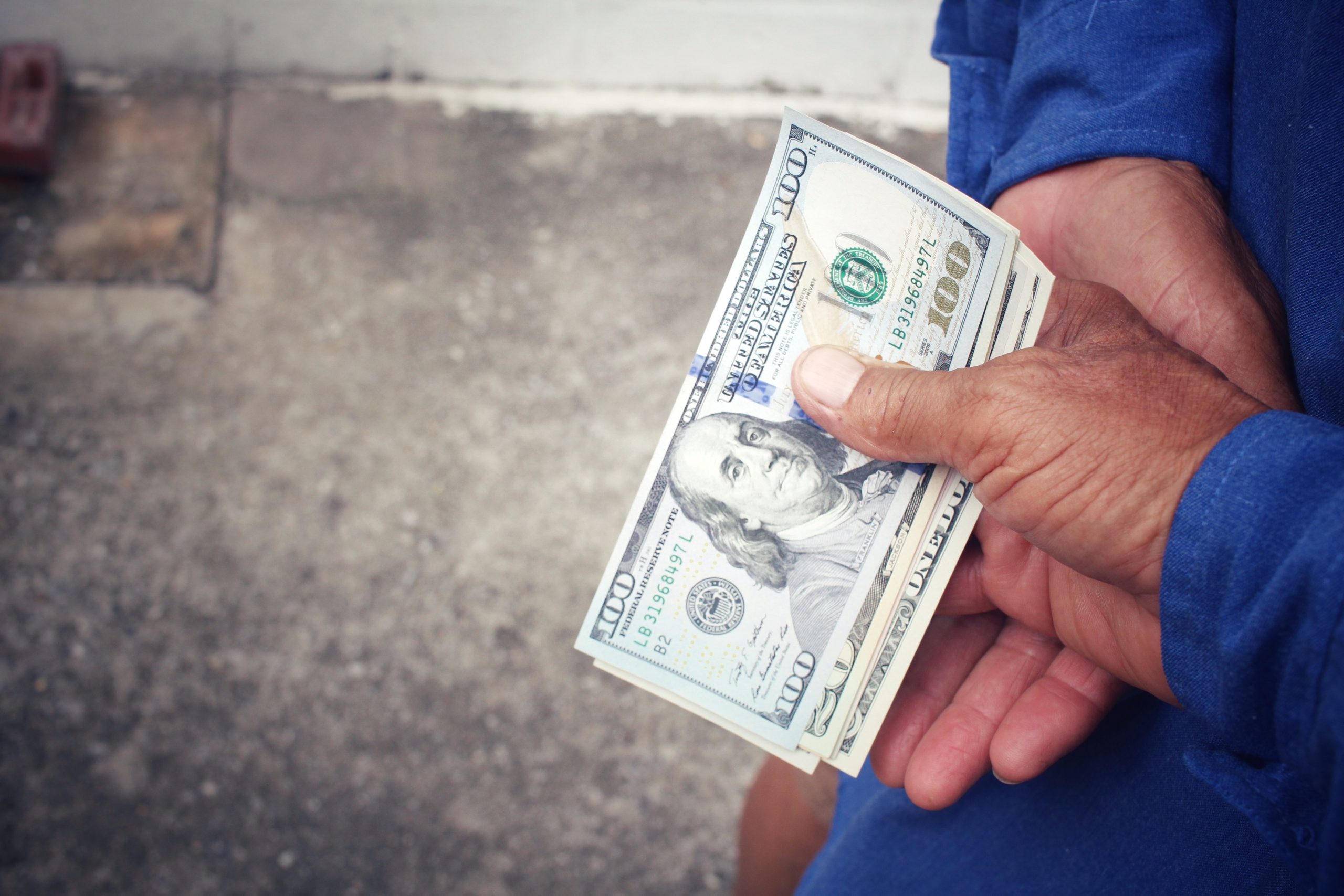 Senior man holding of dollars