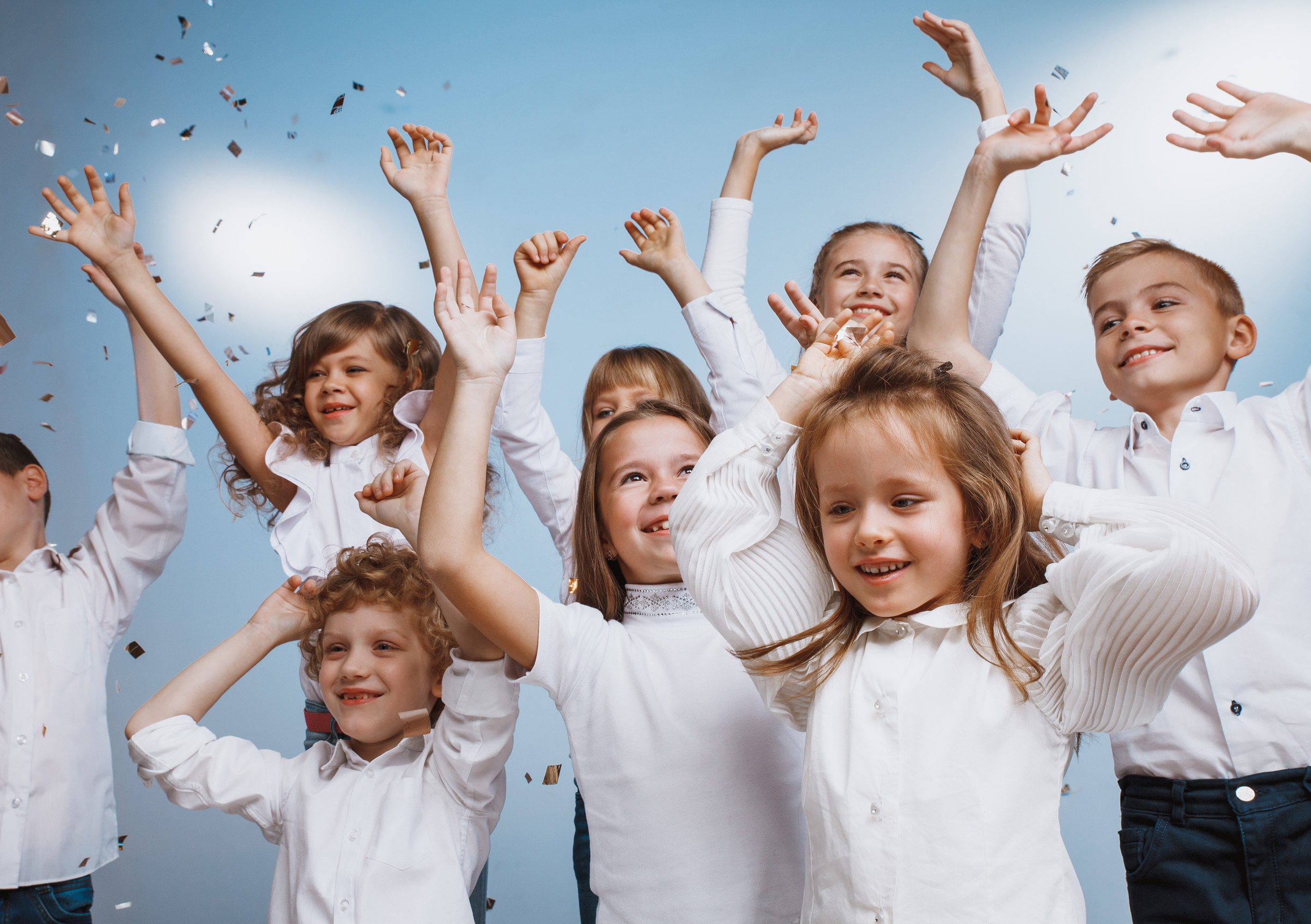 Children with their hands raised