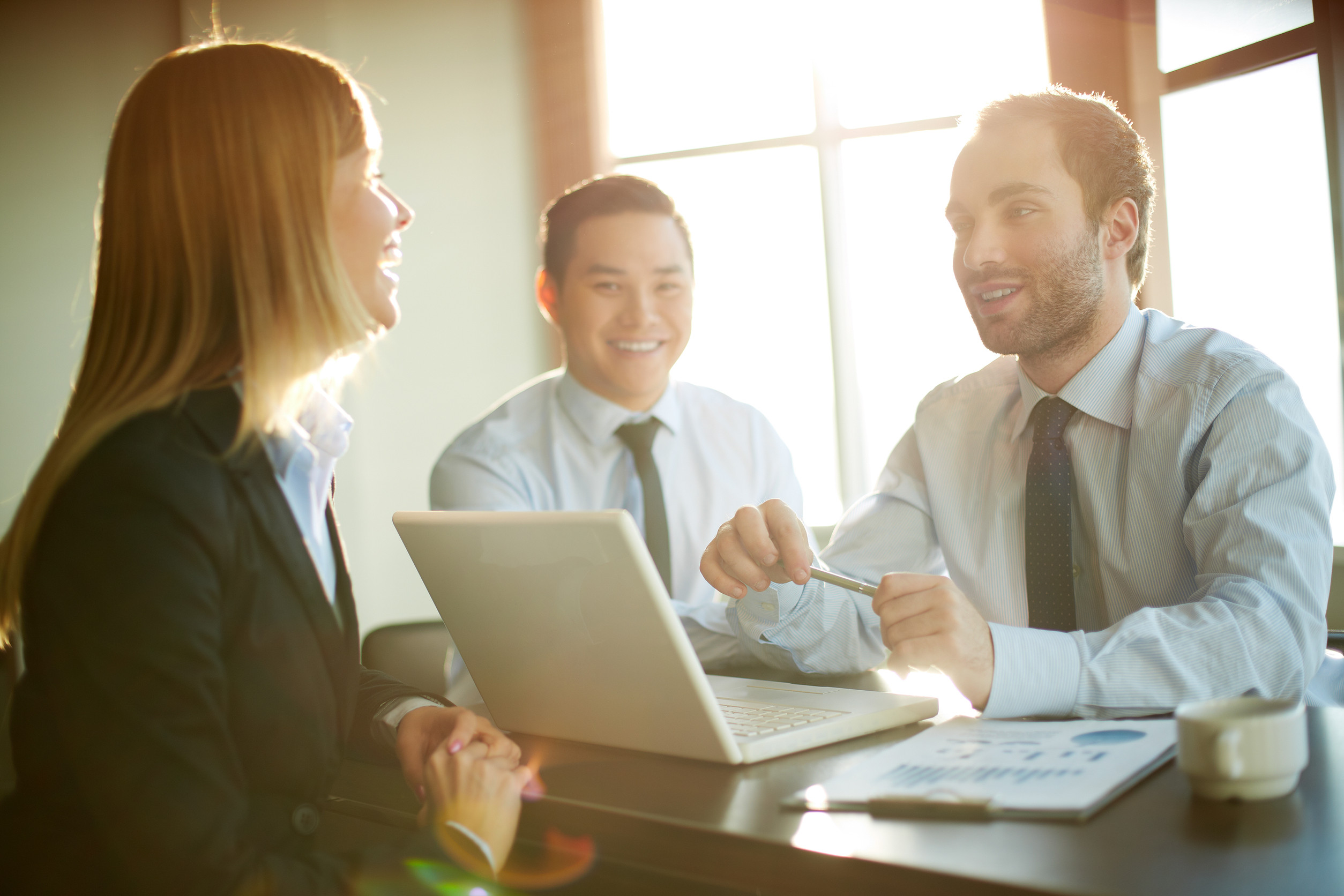 Portrait of smart business partners communicating at meeting