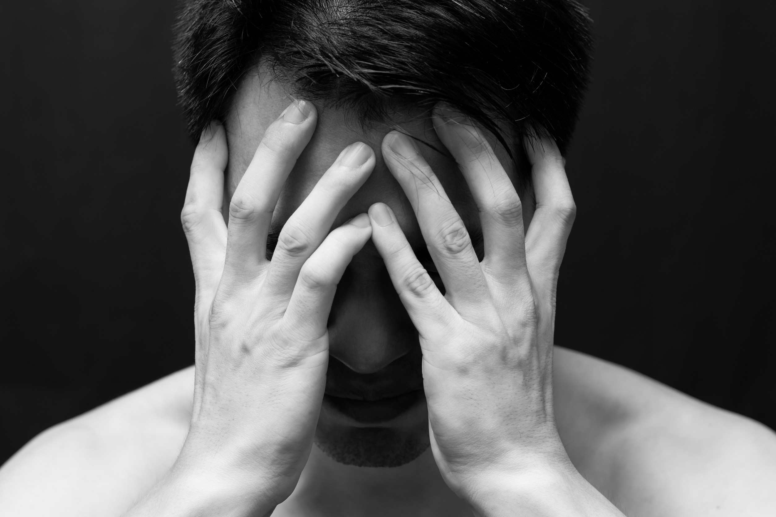 asian handsome man in black and white emotion portrait photo / feel sad ,headache and alone on dark background