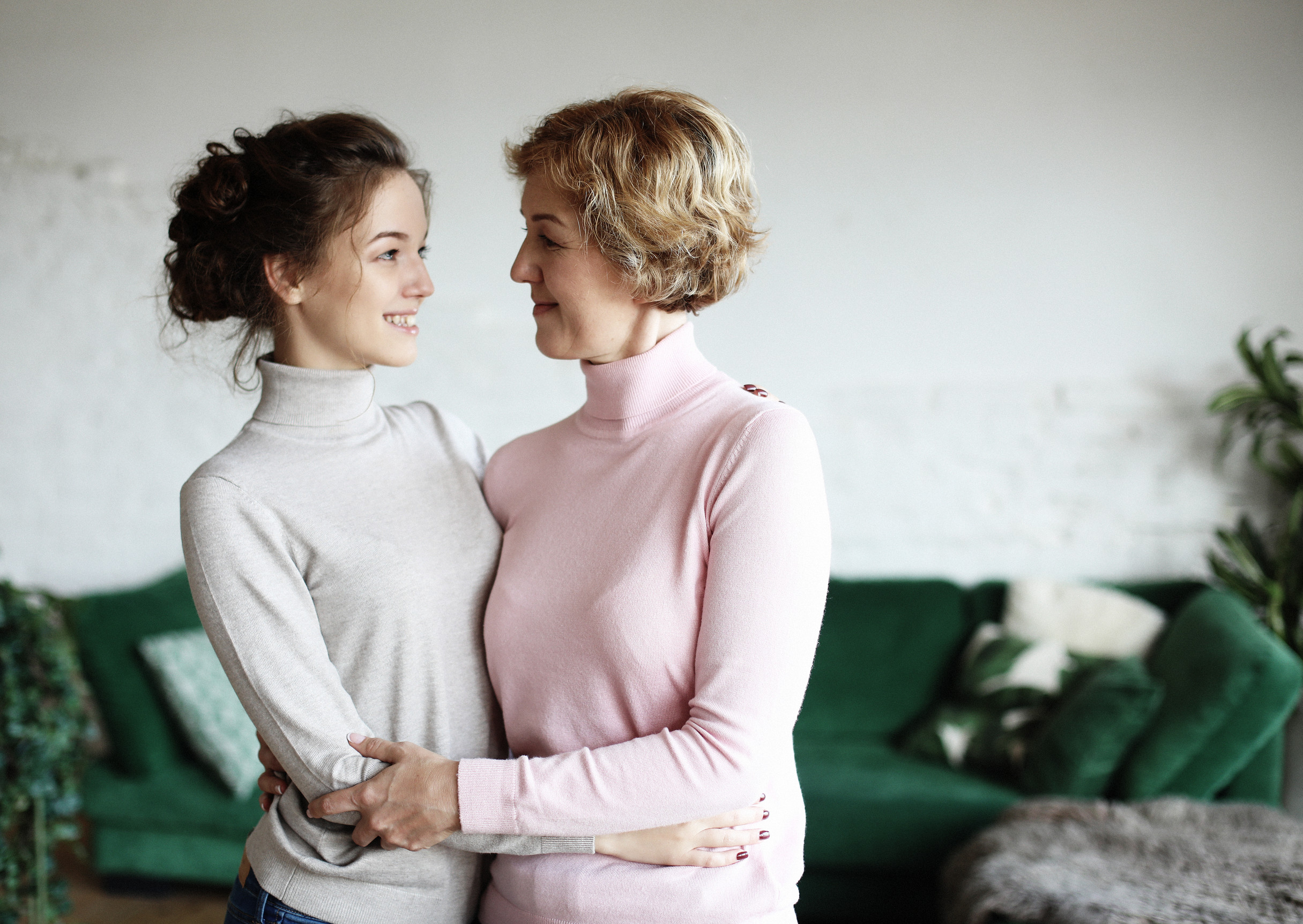 lifestyle, family and people concept: young woman and her mother at home