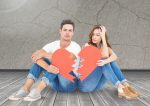 Upset couple holding broken heart against digitally generated wall background