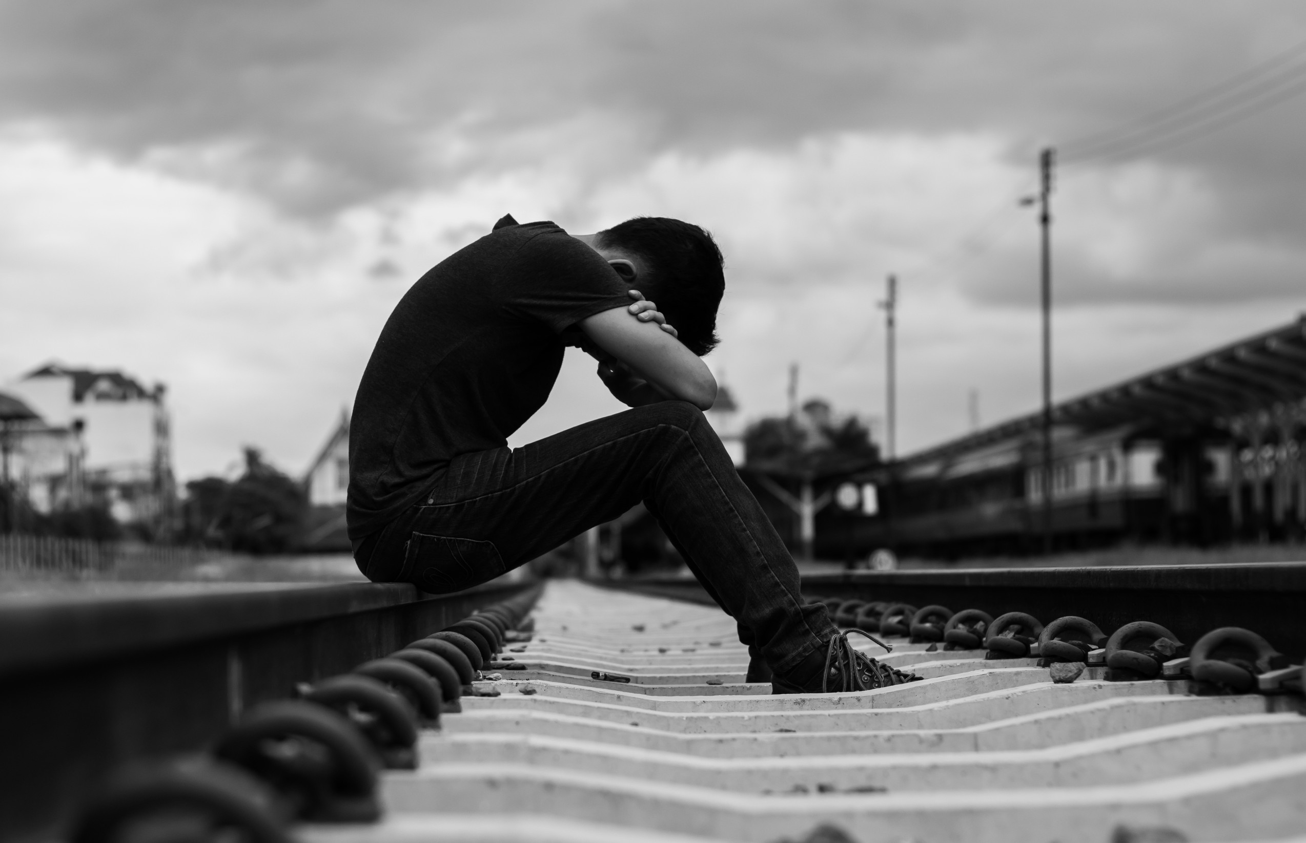 sad man sitting at trian