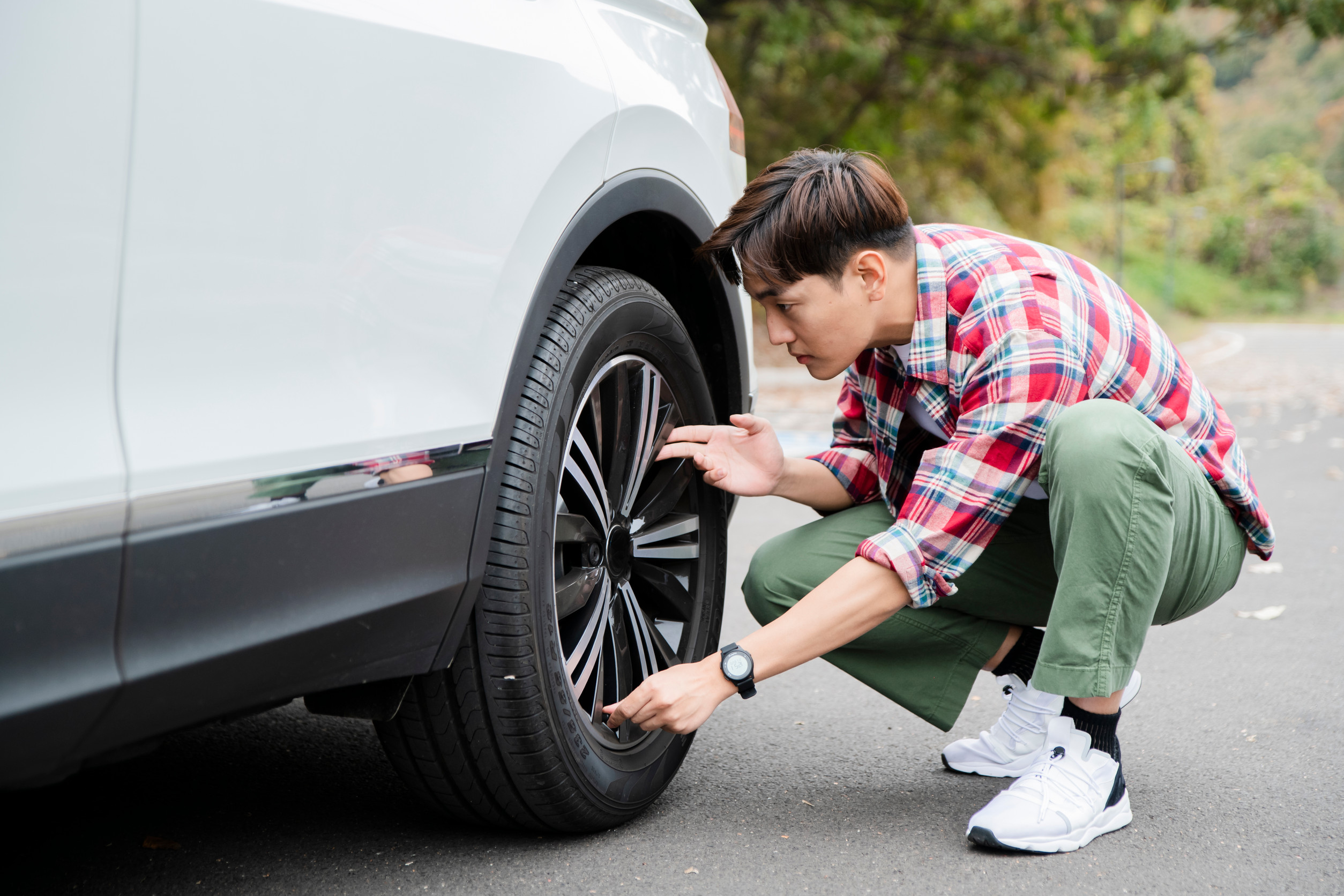 Man looking at tire