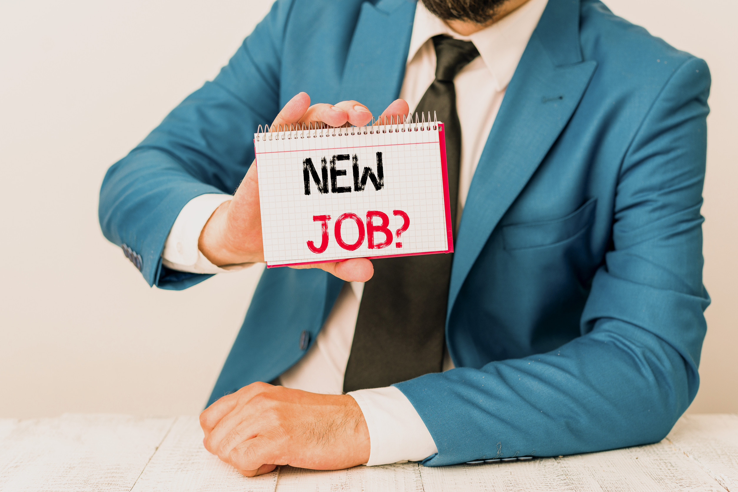 Text sign showing New Job Question. Business photo showcasing asking if a demonstrating got regular work to earn money Man holds empty paper with copy space in front of him Copy Space