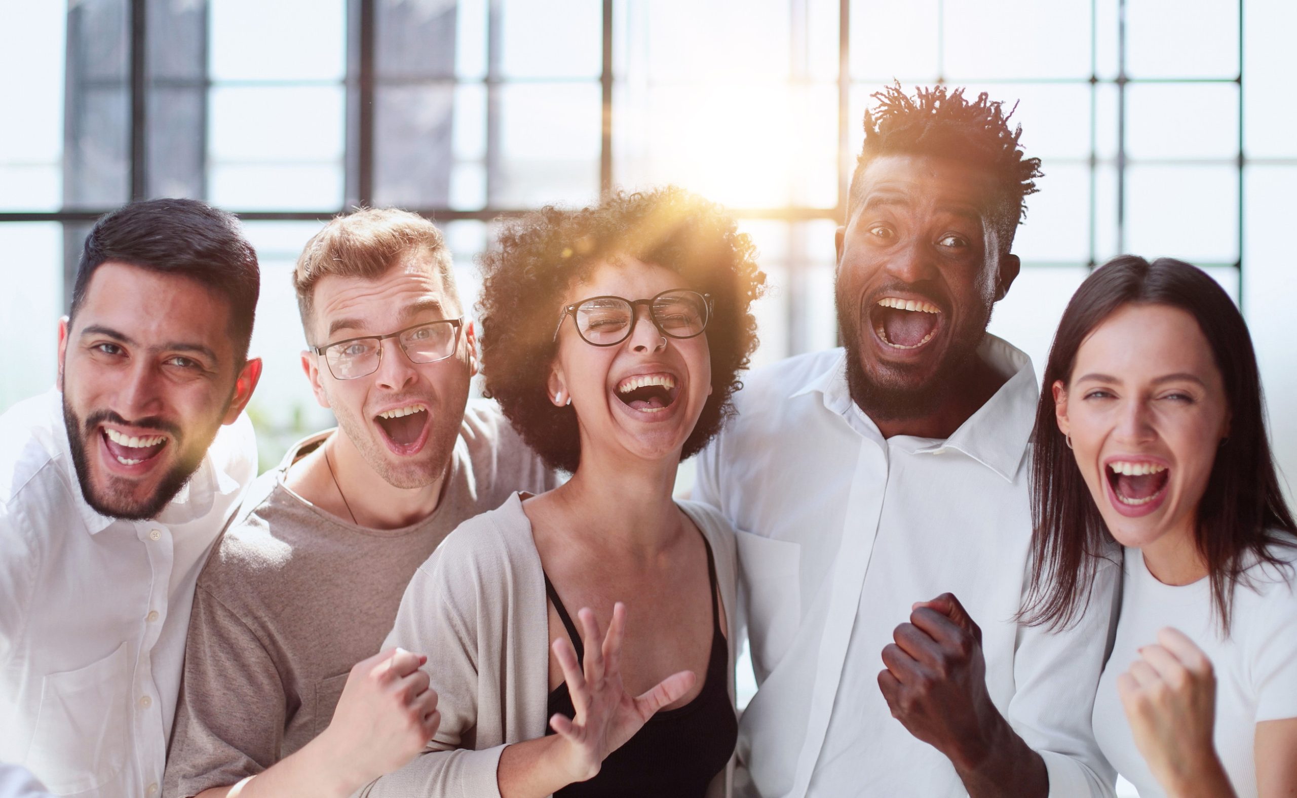 Portrait of successful creative business team looking at camera and smiling. Diverse business people standing together at startup.