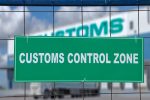 Logistics complex behind the green sign, customs control zone.