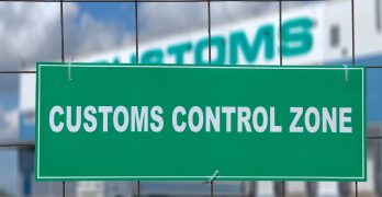 Logistics complex behind the green sign, customs control zone.