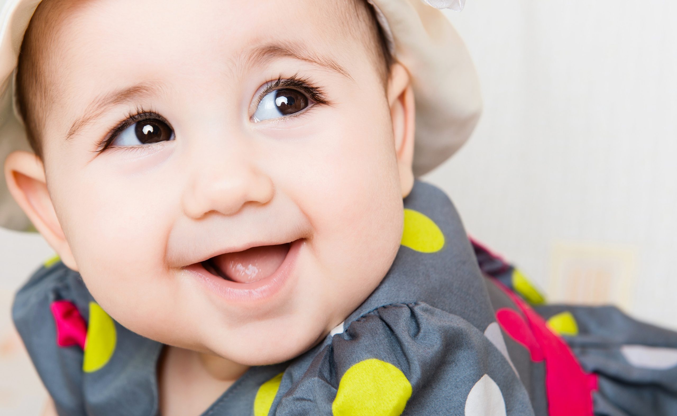 Closeup portrait of beautiful smiling baby girl in hat